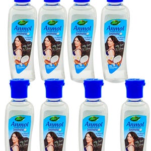 May include: A group of Dabur Anmol Jasmine Coconut Hair Oil bottles. Each clear bottle has a blue cap and a label with a woman, coconut, and flower design. The label includes the text "Anmol Jasmine" and "Almond Protein".