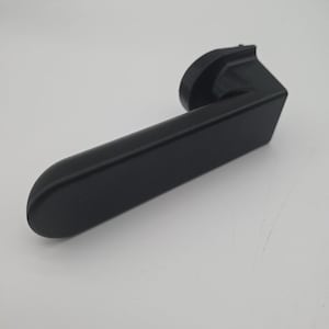 May include: A black door handle with a curved lever and a rectangular base. The handle is made of a matte material and is set against a white background. The design is modern and minimalist.