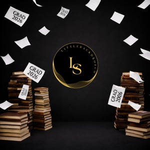 May include: A graduation-themed backdrop with stacks of books and floating papers. The papers read "GRAD 2026". A gold and black circular logo is in the center. The backdrop is black.