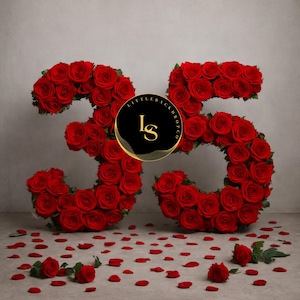 May include: A floral arrangement in the shape of the number 35, crafted from vibrant red roses. Scattered rose petals and individual roses are at the base. The image includes a logo that says "Little Backdrop Co."