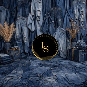 May include: A backdrop featuring a variety of blue denim jeans, some with distressed details. The jeans are arranged to create a textured surface and background. A black circle with gold text and design is in the foreground.