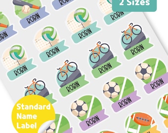 May include: Sheet of sports-themed name labels with illustrations of baseball, volleyball, soccer, football, and bicycles. Each label has the name "ROBIN" printed on it. The labels are available in two sizes, as indicated by the text on the image.