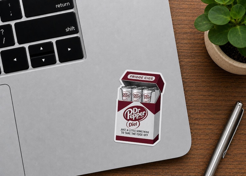 May include: A rectangular sticker featuring a maroon and white box design that mimics a cigarette pack. The box is labeled FRIDGE CIGS at the top and contains silver soda cans. It features the Dr Pepper Diet logo and the text JUST A LITTLE SOMETHING TO TAKE THE EDGE OFF.