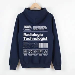 May include: Navy blue hoodie with the text "Radiologic Technologist" in white. The back of the hoodie features a list of ingredients and icons. The hoodie is hanging on a wooden hanger.