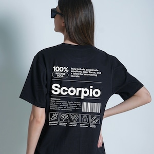 Pode incluir: Camiseta preta com texto e gr&aacute;ficos brancos. A camiseta apresenta a palavra "Scorpio" e o texto "100% Intense Soul". Texto adicional descreve os tra&ccedil;os de Escorpi&atilde;o e inclui &iacute;cones.