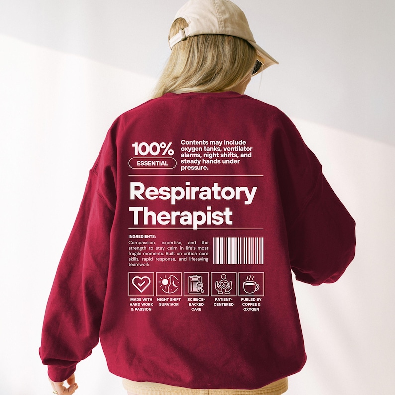 May include: A maroon sweatshirt with the words "Respiratory Therapist" in large white letters. The back of the sweatshirt has text that reads "100% Essential" and lists ingredients like compassion and expertise. There are also icons representing key qualities.