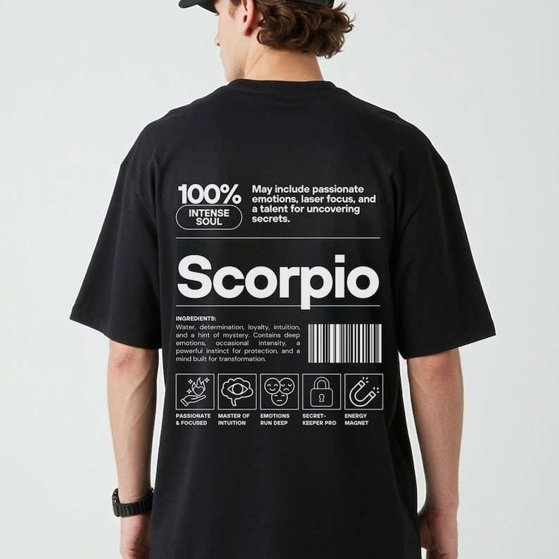 Pode incluir: Camiseta preta com texto e gr&aacute;ficos brancos. A camiseta apresenta a palavra "Scorpio" e a frase "100% Intense Soul". Texto adicional descreve os tra&ccedil;os de Escorpi&atilde;o e inclui &iacute;cones. H&aacute; tamb&eacute;m um c&oacute;digo de barras.