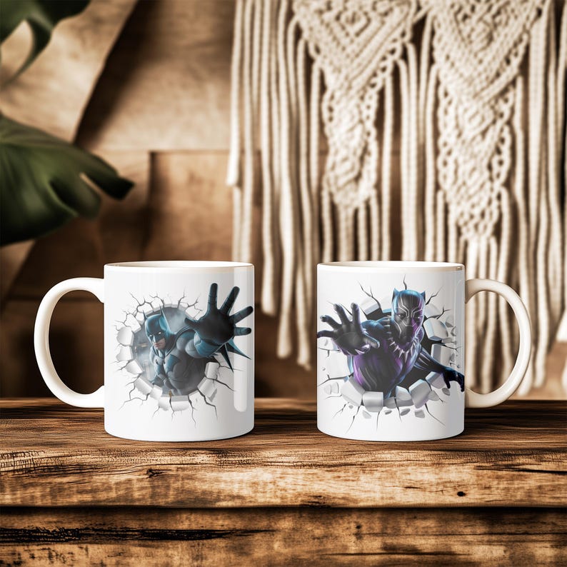 May include: Two white ceramic mugs with superhero designs. One mug features a blue and gray superhero bursting through a cracked wall, reaching out. The other mug has a purple and black superhero with a similar design.