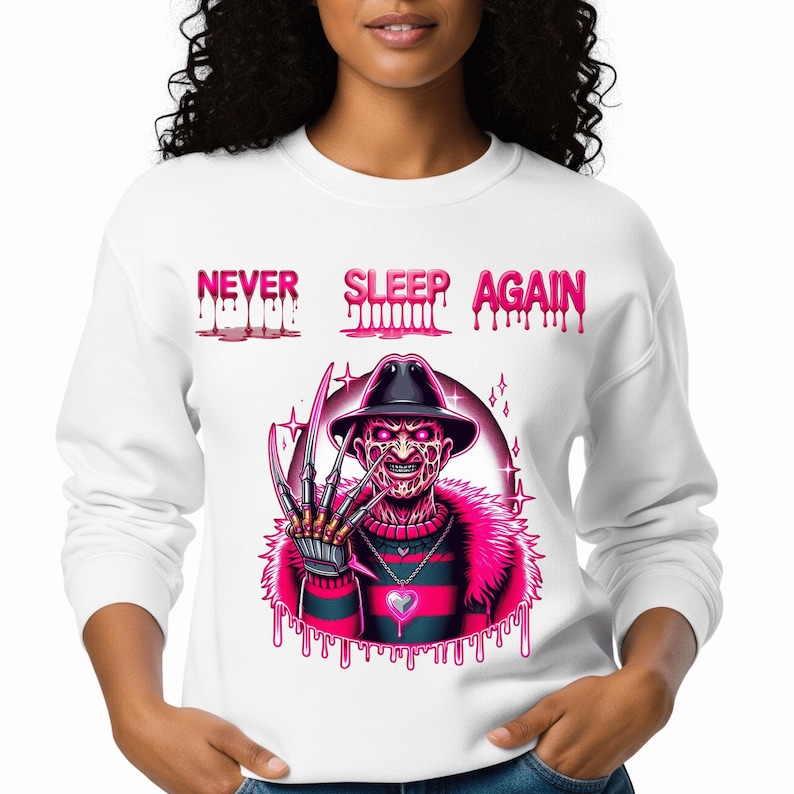 May include: White sweatshirt with a graphic of Freddy Krueger in a hat and claws, with the text "NEVER SLEEP AGAIN" in pink dripping letters. The design features a pink and black striped sweater and a pink fur collar.