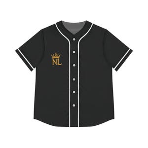 May include: Black baseball jersey with white trim on the collar, sleeves, and button placket. The jersey features a gold crown and the letters "NL" on the left chest.