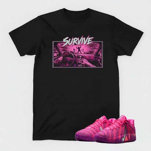 May include: Black t-shirt with a graphic featuring the word "SURVIVE" above a car interior scene in pink and purple. Below the shirt are a pair of pink and purple athletic shoes.