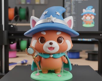 May include: A whimsical figurine of a red panda wizard, wearing a blue hat with stars and a matching cape. The panda holds a staff with a blue orb, standing on a green base with pink flowers. The background includes a computer screen and 3D printing supplies.