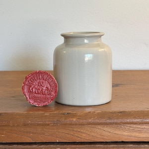 May include: A white ceramic mug with a black handle and the text "But First, Coffee" in a black, handwritten-style font. The mug is likely 11-15 ounces and sits on a white surface.