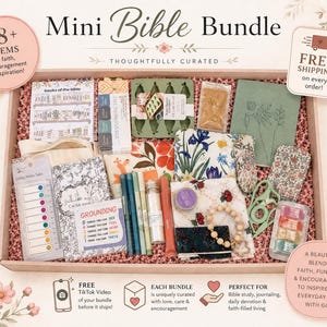 May include: A Mini Bible Bundle gift box containing over 18 items including a books of the Bible chart, sticky index tabs, a grounding card, pens, a floral pouch, a green notebook, a wooden bead bracelet, and various stationery accessories.