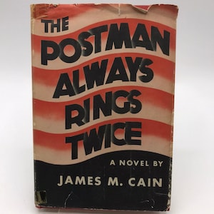 May include: Vintage paperback book titled "The Postman Always Rings Twice" by James M. Cain. The cover features bold black text against a red and white striped background, with a black lower section.