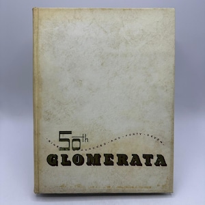 May include: A vintage yearbook with a textured, off-white cover. The cover features the text "56th GLOMERATA" in a dark green font, with additional text above and below. The book has a slightly aged appearance.