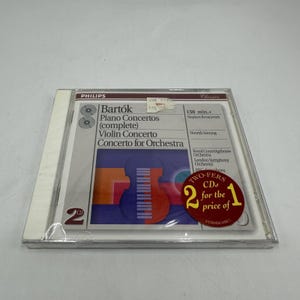 May include: A Philips CD case featuring Bartók's Piano Concertos, Violin Concerto, and Concerto for Orchestra. The cover art includes a stylized violin graphic in orange and red against a blue background. The CD case has a sticker that says "TWO-FERS CDs for the price of 1".