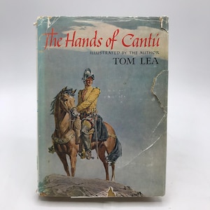 May include: Vintage book cover titled "The Hands of Cantú" with illustration of a man in historical attire on horseback. The cover features a faded blue background and the author's name, Tom Lea.