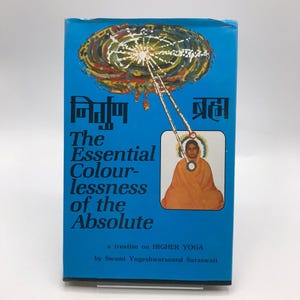 May include: A blue book cover with a colorful illustration of a swirling galaxy and a seated figure in orange robes. The title is "The Essential Colourlessness of the Absolute" and the text "a treatise on HIGHER YOGA by Swami Yogeshwaranand Saraswati" is printed below.