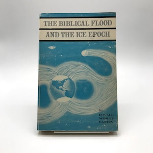 May include: A vintage book titled "The Biblical Flood and the Ice Epoch" with a light blue cover. The cover features a stylized illustration of the Earth and swirling white lines. The author's name, Donald Wesley Patten, is printed at the bottom.