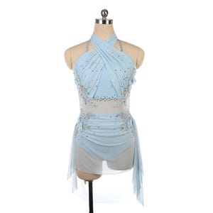 以下が含まれることがあります： ホルターネックとクロスボディスを備えた、水色のダンスコスチューム。コスチュームは、シアーパネル、装飾的な花のアクセント、流れるようなスカートのオーバーレイが特徴です。ラインストーンとシルバーのビーズが輝きを添えています。