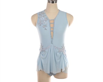 May include: A light blue figure skating dress with a sleeveless design. The bodice features a V-neck with decorative cutouts and is embellished with silver and white floral appliqués and rhinestones. The skirt has a draped, flowing design.