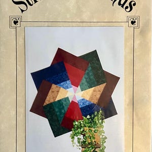 May include: A craft pattern titled "Stitchin' Friends" featuring a colorful pinwheel design. The pinwheel is composed of various fabric squares in shades of red, blue, green, and brown. The image includes the text "Pinwheel Parade".