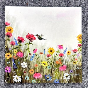 May include: A painting of a hummingbird hovering over a field of colorful wildflowers. The flowers are in shades of pink, red, yellow, and blue. The hummingbird is green and brown with a long, thin beak. The background is a light blue sky.