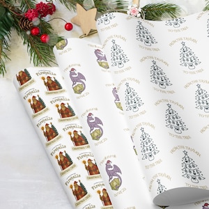 May include: Three rolls of Christmas wrapping paper. One roll features Santa Claus with the text "Fireballs" and "Christmas Cheer." Another roll has a purple dragon with the text "May your role" and "boNot 20s." The third roll has Christmas trees with the text "From the Tavern" and "To the Tree."