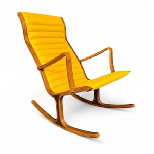 May include: A mid-century modern rocking chair with a bright yellow, padded seat and backrest. The chair has a wooden frame with curved armrests and rockers. The chair's design is simple and elegant, with a focus on comfort and style.