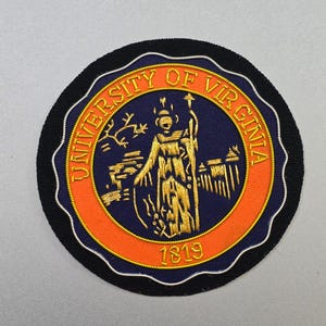 May include: Embroidered patch featuring the University of Virginia seal. The circular patch has a black border, a white scalloped edge, and an orange inner ring. The seal includes text that reads "UNIVERSITY OF VIRGINIA" and the year "1819".