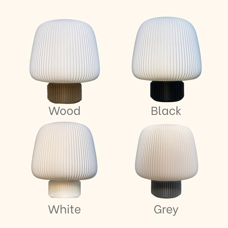 May include: Four mushroom-shaped lamps with ribbed, white shades. The bases are wood, black, white, and grey. The lamps are a modern design, suitable for home decor and lighting.
