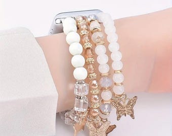 Pode incluir: Um conjunto de pulseiras de contas em tons de branco, dourado e pêssego. As pulseiras apresentam vários tamanhos e formas de contas, com pingentes de borboleta. O texto "3 Color, 2 Model" está na parte inferior.