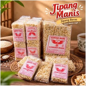 May include: Several rectangular clear plastic packages of Jipang Manis puffed rice snacks. Each package features a white label with a red Garuda bird logo and the text Garuda Mass Jipang Manis. The snacks are light tan and textured.
