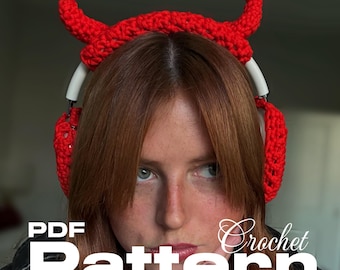May include: A red crochet devil horn headband worn over white headphones. The image includes the text "PDF Pattern Crochet". The headband is a handmade accessory, likely for cosplay or themed events.