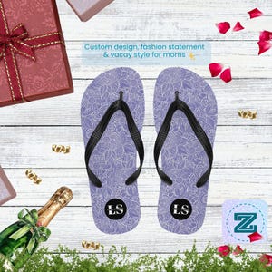 May include: A pair of lavender flip-flops with a white floral pattern and black straps. The text on the flip-flops reads "LS". The image also includes the text "Custom design, fashion statement & vacay style for moms".