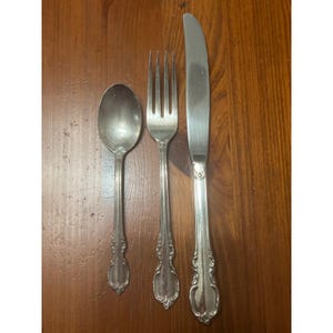 May include: A set of three ceramic mugs with a speckled, matte finish. The mugs are in shades of cream, light gray, and dark gray. Each mug has a simple, minimalist design, perfect for coffee or tea.