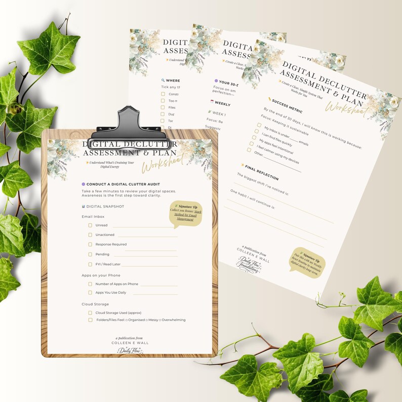 May include: A wooden clipboard holds a "Digital Declutter Assessment & Plan Worksheet" with floral accents. Two additional worksheets are visible. Green ivy and floral elements decorate the background. The worksheets contain checklists and prompts for digital organization.