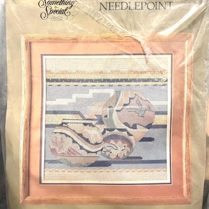 May include: Needlepoint kit featuring a Southwestern design with three detailed pots in shades of tan, blue, and red. The finished size is 14" x 14", matted size 18" x 18". The kit includes canvas, floss, and instructions.