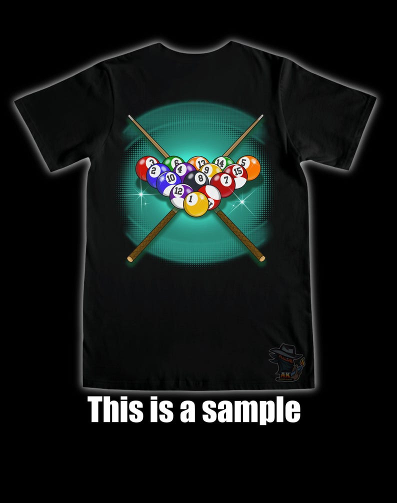 May include: Black t-shirt featuring a graphic of a rack of billiard balls with crossed pool cues. The balls are numbered and arranged in a triangle. The text "This is a sample" is at the bottom of the shirt.