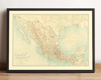 May include: Framed vintage map of Mexico, featuring detailed geographical information. The map is in shades of beige, brown, and blue, with the word "MEXICO" at the bottom left. The map is framed in a black frame and is displayed on a wooden surface.
