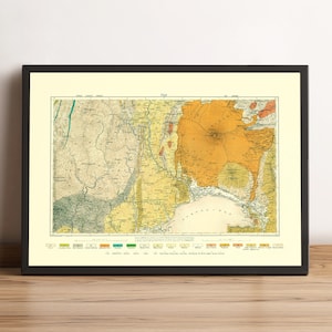 May include: Framed vintage map of Fiji, featuring detailed geographical information. The map uses a palette of beige, yellow, green, and orange hues. The map is encased in a black frame, suitable for home or office decor.
