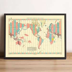 May include: Framed world map showing time zones, with a cream-colored background and colorful stripes in shades of pink, teal, and yellow. The title "TIME ZONE CHART OF THE WORLD" is printed at the top. The map is in a black frame.