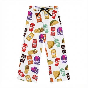 May include: White pajama pants featuring a repeating pattern of Taco Bell food items and logos. The design includes tacos, burritos, sauce packets, and the Taco Bell logo in red, purple, and yellow.