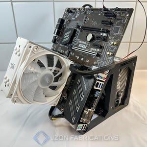 May include: A computer build featuring a white CPU cooler with a fan, a black and grey motherboard, and a black case. The components are arranged to showcase the internal structure of a computer. The image includes the text "JON FABRICATIONS".