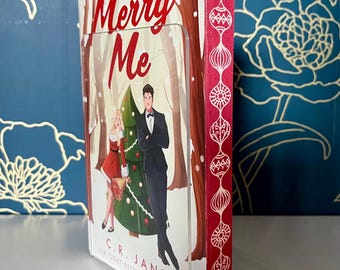 Paperback book “Merry Me” by C.R. Jane with custom sprayed ornament edges
