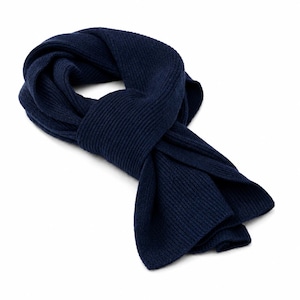 May include: A solid navy blue scarf featuring a distinct ribbed knit texture. The scarf is arranged in a loose, looped knot, showcasing the consistent vertical lines of the knit pattern throughout the length of the fabric against a white background.