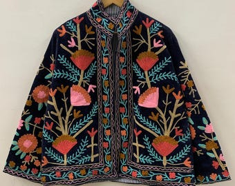 May include: A navy blue jacket with colorful floral embroidery. The jacket features a high collar and a striped lining. The embroidery includes pink, orange, and teal flowers and leaves, with gold and brown stems.