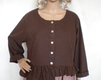 May include: A brown button-up blouse with a ruffle trim at the bottom. The blouse has long sleeves and a scoop neckline.