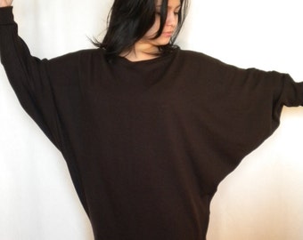 May include: A brown, oversized, long-sleeved sweater with a relaxed fit.